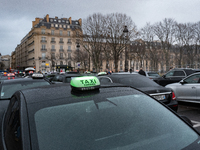 Taxi drivers gather at the Invalides in Paris, France, on December 3, 2024, during a demonstration against a new downward pricing system for...