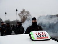 Taxi drivers gather at the Invalides in Paris, France, on December 3, 2024, during a demonstration against a new downward pricing system for...