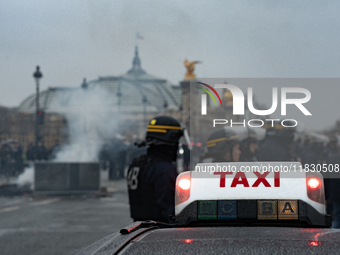 Taxi drivers gather at the Invalides in Paris, France, on December 3, 2024, during a demonstration against a new downward pricing system for...