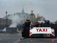 Taxi drivers gather at the Invalides in Paris, France, on December 3, 2024, during a demonstration against a new downward pricing system for...