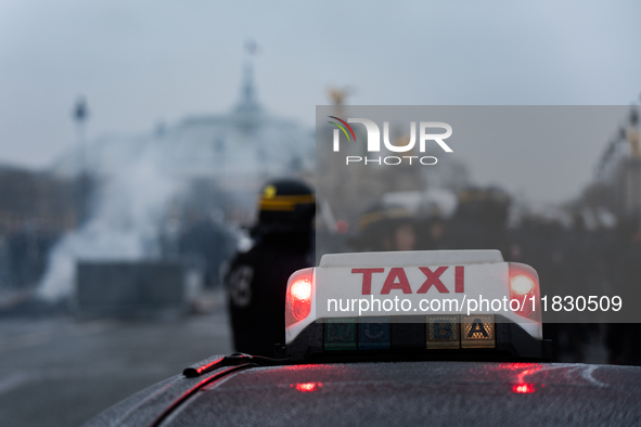 Taxi drivers gather at the Invalides in Paris, France, on December 3, 2024, during a demonstration against a new downward pricing system for...