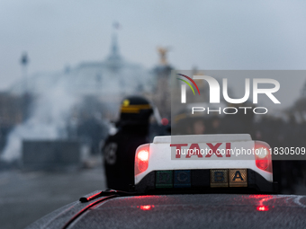 Taxi drivers gather at the Invalides in Paris, France, on December 3, 2024, during a demonstration against a new downward pricing system for...