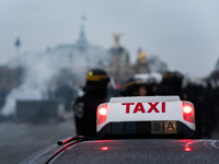 Taxi drivers gather at the Invalides in Paris, France, on December 3, 2024, during a demonstration against a new downward pricing system for...