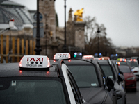 Taxi drivers gather at the Invalides in Paris, France, on December 3, 2024, during a demonstration against a new downward pricing system for...