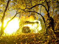 An artilleryman of the Khyzhak Patrol Police Special Unit fires a howitzer while on a combat mission at the positions in Donetsk region, eas...