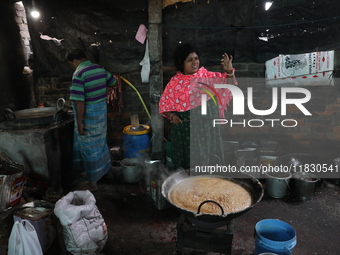 Workers prepare date palm jaggery before making ''Joynagar Moa of West Bengal,'' an Indian sweet made with folk rice mixed with date molasse...