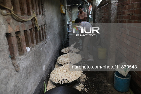 Workers prepare ''Joynagar Moa of West Bengal,'' an Indian sweet made with folk rice mixed with date molasses, inside a workshop at Jayanaga...