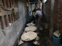 Workers prepare ''Joynagar Moa of West Bengal,'' an Indian sweet made with folk rice mixed with date molasses, inside a workshop at Jayanaga...