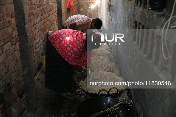 Workers prepare ''Joynagar Moa of West Bengal,'' an Indian sweet made with folk rice mixed with date molasses, inside a workshop at Jayanaga...