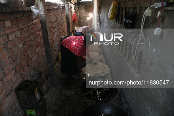 Workers prepare ''Joynagar Moa of West Bengal,'' an Indian sweet made with folk rice mixed with date molasses, inside a workshop at Jayanaga...