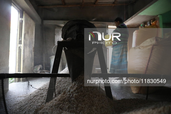 A worker prepares ''Joynagar Moa of West Bengal,'' an Indian sweet made with folk rice mixed with date molasses, inside a workshop at Jayana...