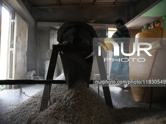 A worker prepares ''Joynagar Moa of West Bengal,'' an Indian sweet made with folk rice mixed with date molasses, inside a workshop at Jayana...