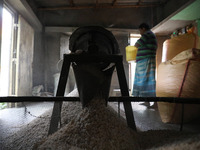 A worker prepares ''Joynagar Moa of West Bengal,'' an Indian sweet made with folk rice mixed with date molasses, inside a workshop at Jayana...