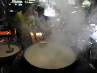 Workers prepare date palm jaggery before making ''Joynagar Moa of West Bengal,'' an Indian sweet made with folk rice mixed with date molasse...