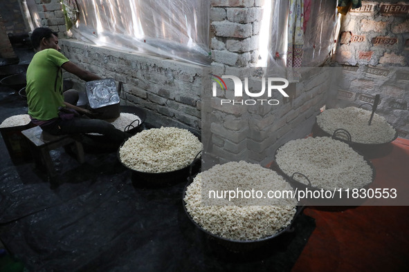 A worker prepares ''Joynagar Moa of West Bengal,'' an Indian sweet made with folk rice mixed with date molasses, inside a workshop at Jayana...