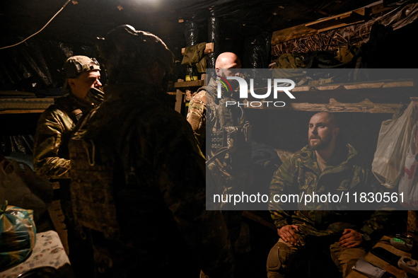 Artillerymen of the Khyzhak Patrol Police Special Unit stay in a dugout while on a combat mission at the positions in Donetsk region, easter...