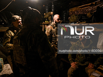 Artillerymen of the Khyzhak Patrol Police Special Unit stay in a dugout while on a combat mission at the positions in Donetsk region, easter...