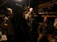 Artillerymen of the Khyzhak Patrol Police Special Unit stay in a dugout while on a combat mission at the positions in Donetsk region, easter...