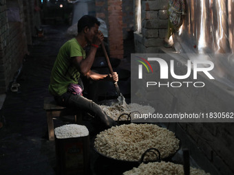 A worker prepares ''Joynagar Moa of West Bengal,'' an Indian sweet made with folk rice mixed with date molasses, inside a workshop at Jayana...