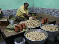 A man prepares ''Joynagar Moa of West Bengal'' (an Indian sweet) made with folk rice mixed with date molasses inside a workshop at Jayanagar...