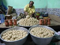 A man prepares ''Joynagar Moa of West Bengal'' (an Indian sweet) made with folk rice mixed with date molasses inside a workshop at Jayanagar...