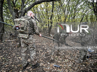 Artillerymen of the Khyzhak Patrol Police Special Unit are on a combat mission at the positions in Donetsk region, eastern Ukraine, on Octob...