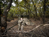 Artillerymen of the Khyzhak Patrol Police Special Unit clean the barrel of a howitzer while on a combat mission at the positions in Donetsk...