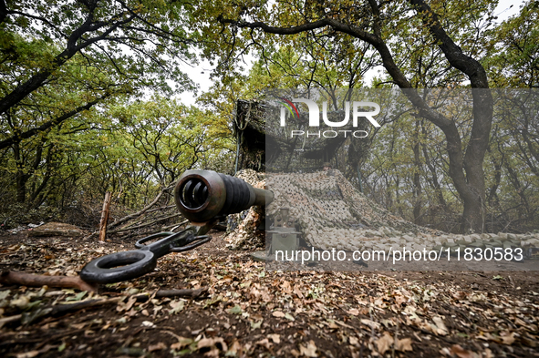 A howitzer is under a camouflage net as the artillerymen of the Khyzhak Patrol Police Special Unit are on a combat mission at the positions...