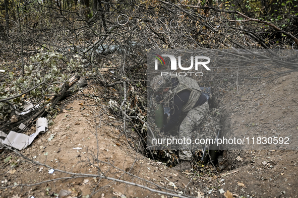 An artilleryman of the Khyzhak Patrol Police Special Unit is on a combat mission at the positions in Donetsk region, eastern Ukraine, on Oct...