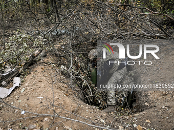 An artilleryman of the Khyzhak Patrol Police Special Unit is on a combat mission at the positions in Donetsk region, eastern Ukraine, on Oct...