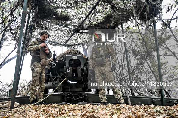 Artillerymen of the Khyzhak Patrol Police Special Unit man a howitzer while on a combat mission at the positions in Donetsk region, eastern...