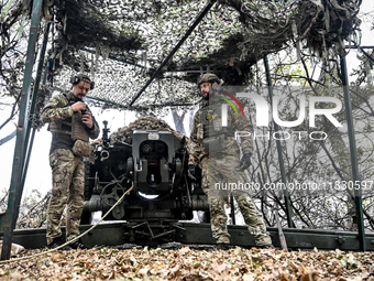 Artillerymen of the Khyzhak Patrol Police Special Unit man a howitzer while on a combat mission at the positions in Donetsk region, eastern...