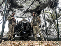 Artillerymen of the Khyzhak Patrol Police Special Unit man a howitzer while on a combat mission at the positions in Donetsk region, eastern...