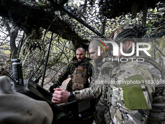 Artillerymen of the Khyzhak Patrol Police Special Unit man a howitzer while on a combat mission at the positions in Donetsk region, eastern...