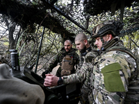 Artillerymen of the Khyzhak Patrol Police Special Unit man a howitzer while on a combat mission at the positions in Donetsk region, eastern...