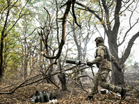 An artilleryman of the Khyzhak Patrol Police Special Unit disposes of an artillery shell case while on a combat mission at the positions in...