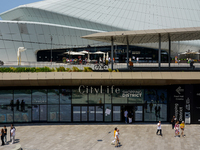 A dynamic atmosphere exists in front of an entrance to the CityLife Shopping District in Milan, Italy, on May 27, 2023. (