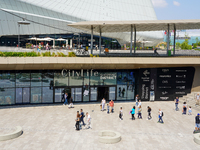 A dynamic atmosphere exists in front of an entrance to the CityLife Shopping District in Milan, Italy, on May 27, 2023. (