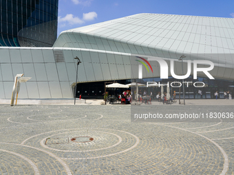 A dynamic atmosphere exists in front of an entrance to the CityLife Shopping District in Milan, Italy, on May 27, 2023. (