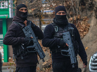 An Indian security personnel stands guard along a road during a gun battle between militants and security forces on the outskirts of Srinaga...