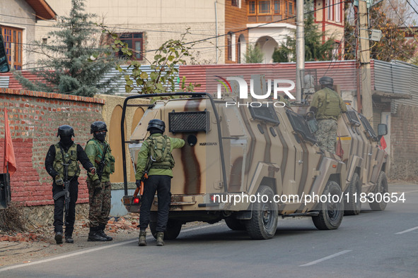 Indian security personnel are near the site of a gun battle between militants and security forces on the outskirts of Srinagar, Jammu and Ka...