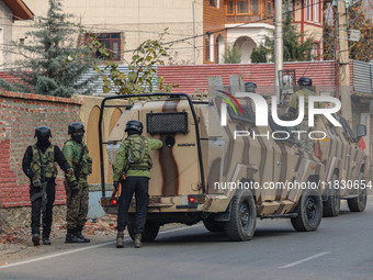 Indian security personnel are near the site of a gun battle between militants and security forces on the outskirts of Srinagar, Jammu and Ka...