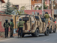 Indian security personnel are near the site of a gun battle between militants and security forces on the outskirts of Srinagar, Jammu and Ka...