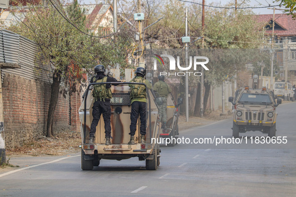 Indian security personnel patrol on armored vehicles near the site of a gun battle between militants and security forces on the outskirts of...