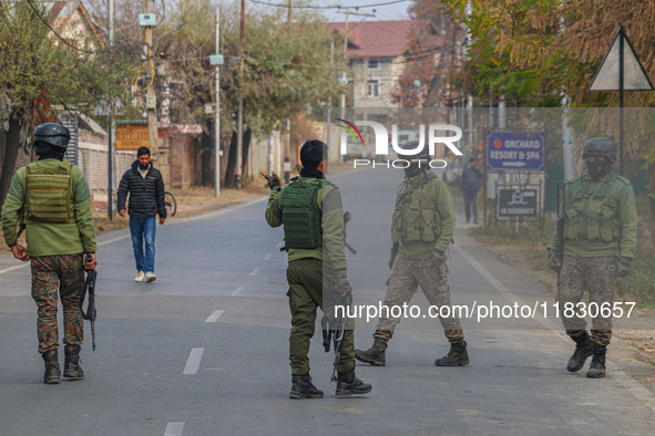 Indian security personnel are near the site of a gun battle between militants and security forces on the outskirts of Srinagar, Jammu and Ka...