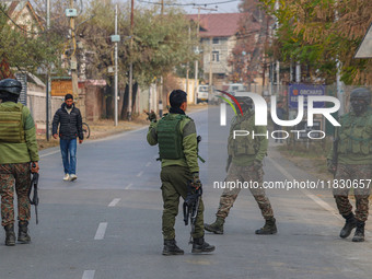 Indian security personnel are near the site of a gun battle between militants and security forces on the outskirts of Srinagar, Jammu and Ka...