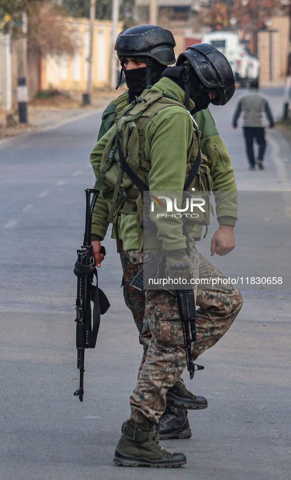 Indian security personnel are near the site of a gun battle between militants and security forces on the outskirts of Srinagar, Jammu and Ka...