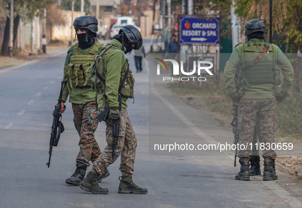 Indian security personnel are near the site of a gun battle between militants and security forces on the outskirts of Srinagar, Jammu and Ka...