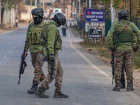 Indian security personnel are near the site of a gun battle between militants and security forces on the outskirts of Srinagar, Jammu and Ka...