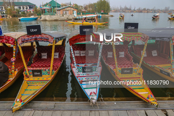 Uber signs are displayed on ''Shikaras'' or small boats after Uber launches its first water transport service on the waters of Dal Lake, in...